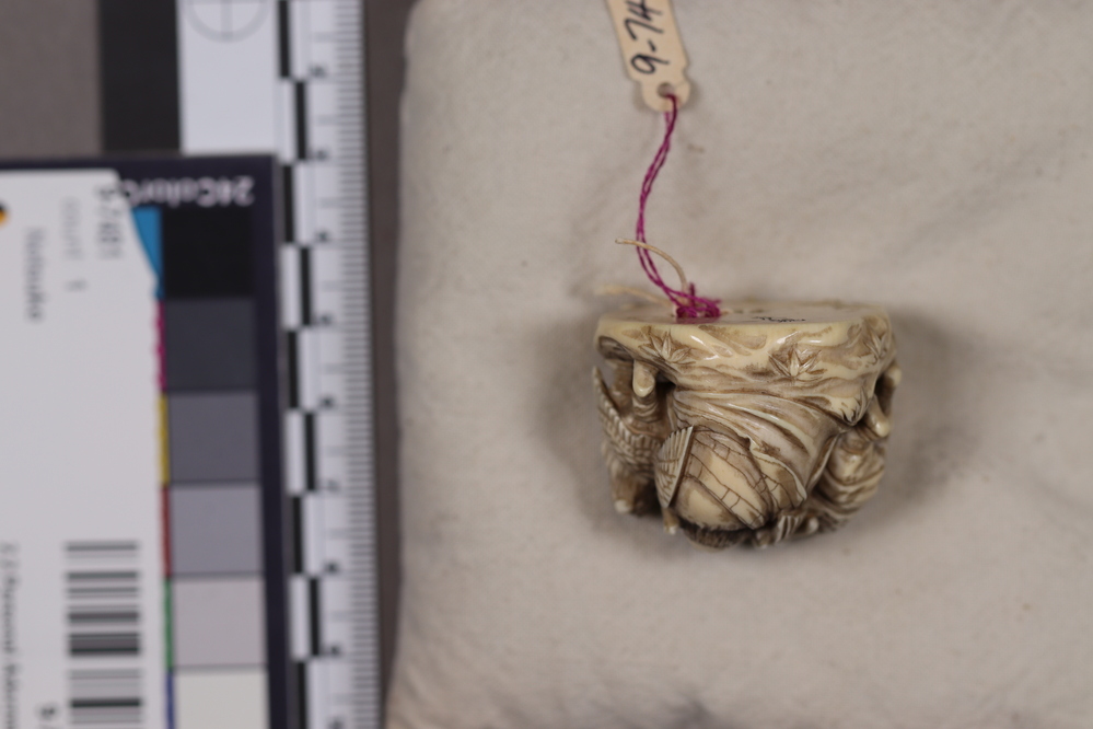 Hearst Museum object 3 of 6 titled Netsuke, accession number 9-7492, described as Netsuke: crowd of beasts with beaks (Tengu) of birds and wings. Principal figure, wearing armor, helmet and club, is female.