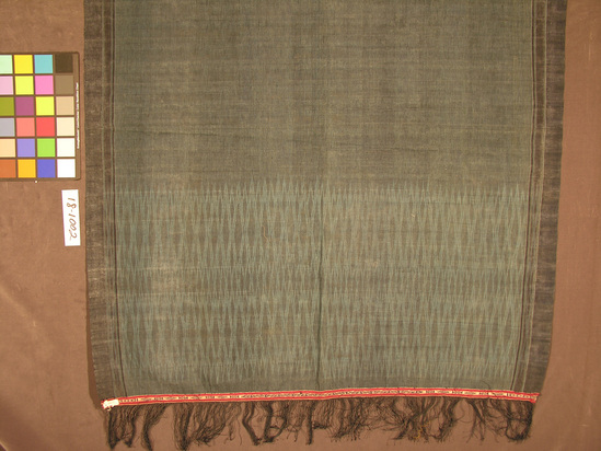 Hearst Museum object titled Shawl, accession number 18-1002, described as Shawl; blue cotton with elongated diamonds in ikat technique; decorative band in red, white and blue at both ends. Length 4.54 m. excluding fringe. Width 1.4 m.