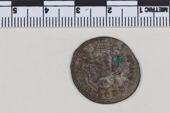 Hearst Museum object 4 of 8 titled Coin: billon antoninianus, accession number 8-4043, described as Coin; AG; Billon. Antoninianus; Roman. 3.60 grams, 24 mm. Aurelian, 270-275 AD. Obverse: IMP AVRELIANVS AVG, Bust r. radiate. Reverse: ORIENS AVG, Sol striding l., two captives at his feet; P in field r., in exergue XXI