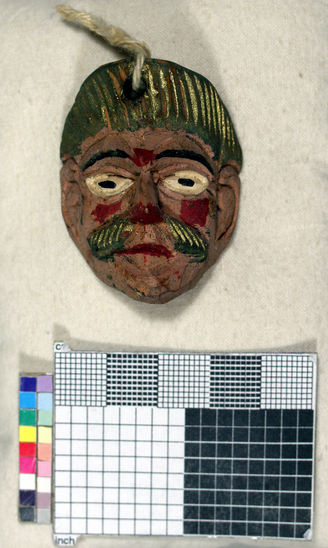 Hearst Museum object titled Toy mask, accession number 3-15589, described as Carved wooden toy mask; painted pink face