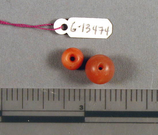 Hearst Museum object titled Beads, accession number 6-13474, described as Beads: 19 carnelian, spherical (ball) and discs; 1 blue glaze tubular; 6 blue glaze barrel-shaped; 1 black spherical (ball).