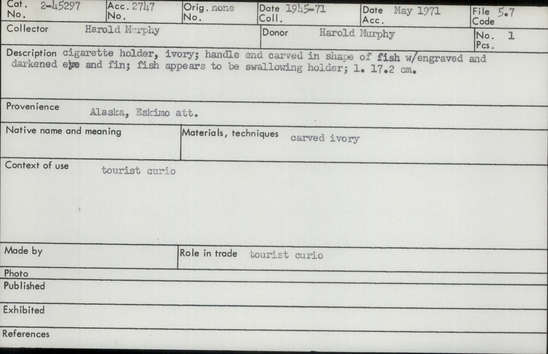 Documentation associated with Hearst Museum object titled Cigarette holder, accession number 2-45297, described as Made of ivory.  Handle end carved in shape of fish with engraved and darkened eye and fin.  Fish apears to be swallowing holder.