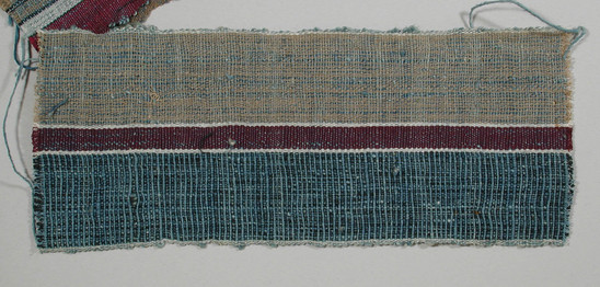 Hearst Museum object titled Textile fragment, accession number 5-11207, described as textile sample (section of narrow band weaving): one side of blue and black threads alternating; other side of tan; center stripe maroon flanked by white.