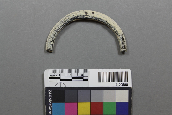 Hearst Museum object titled Bangle fragment, accession number 9-20588, described as portion of a bracelet, white ceramic with some black coloring