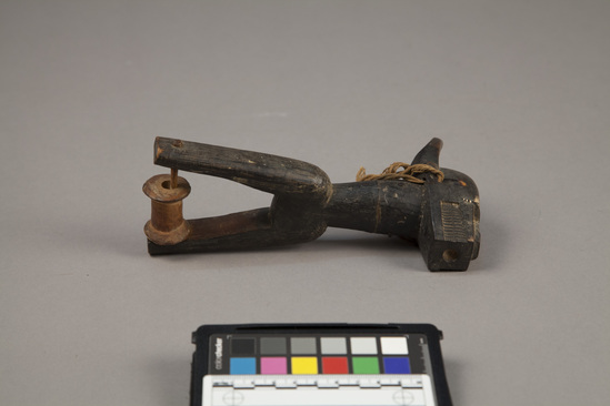 Hearst Museum object 2 of 2 titled Pulley, accession number 5-16339, described as Baule pulley. buffalo. carved, painted wood, with cord, spool and pins.