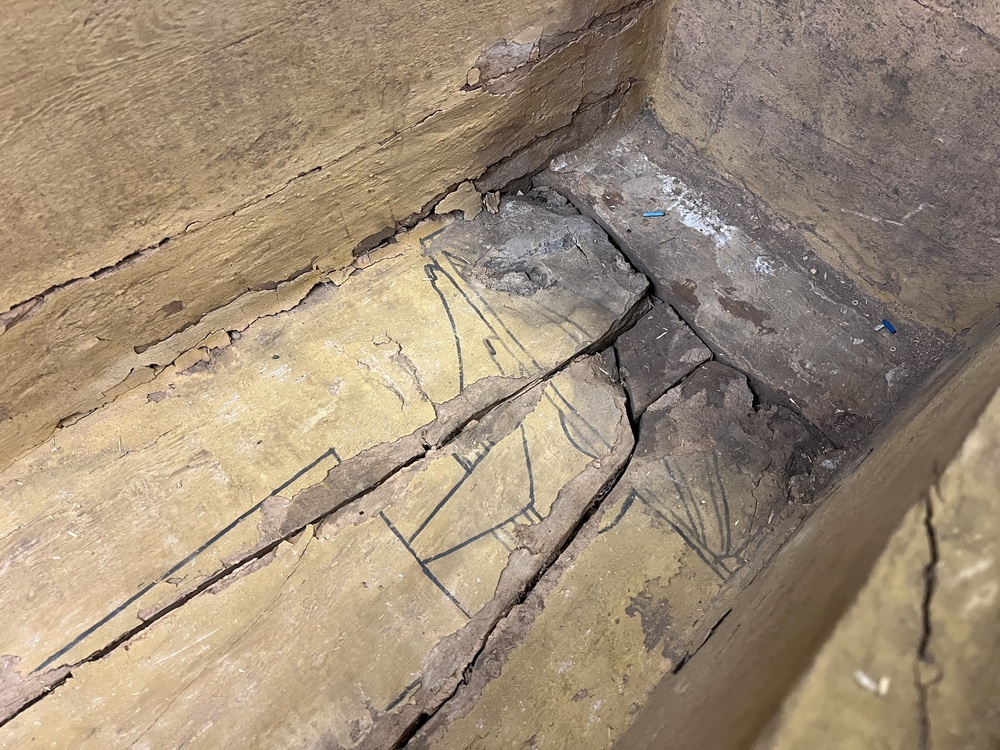 Hearst Museum object 3 of 167 titled Coffin, accession number 6-19912, described as Wooden anthropoid coffin. Inscription running down center of lid. Determined by Kea Johnston to probably be the outer coffin of Iwefaa (6-19928, 12-11039). According to Kea Johnston, "This coffin belonged to a man named Iwefaa, whose name is inserted in the middle of the spells written in the two columns on the front. This coffin is likely the outer coffin for PAHMA 6-19928 based on the similarity of the owner's name, unusual costume, and the paleography of the inscription. Both coffins were purchased on the antiquities market by George Reisner for Phoebe A Hearst. However, stylistically, they are very similar to a set of coffins known to have come from the site of Akhmim, which was excavated in the 1880s by Gaston Maspero, and which has heavily looted for the antiquities market during this decade." "The pectoral vignette between the text and the collar shows the deceased standing before squatting baboon and is the source of our logo. The hieroglyph for 'sky' is above their heads, and the side borders are formed by a pyramid and the symbol for the West.