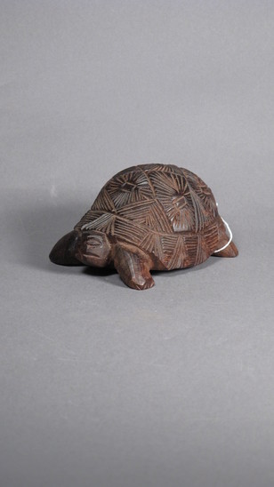 Hearst Museum object titled Turtle figurine, accession number 3-30495, described as wood turtle, incised shell design in dark wood.