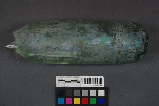 Hearst Museum object titled Bottle fragment, accession number 1-247785, described as Glass bottle; base; neck green stamp (trademark) embossed lettering