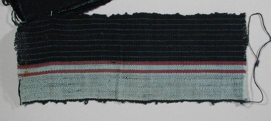 Hearst Museum object titled Textile fragment, accession number 5-11097, described as Textile sample (section of narrow band weaving): Right half: navy with nine pale blue lines; left half: pale blue green with two maroon stripes. Left selvage navy.