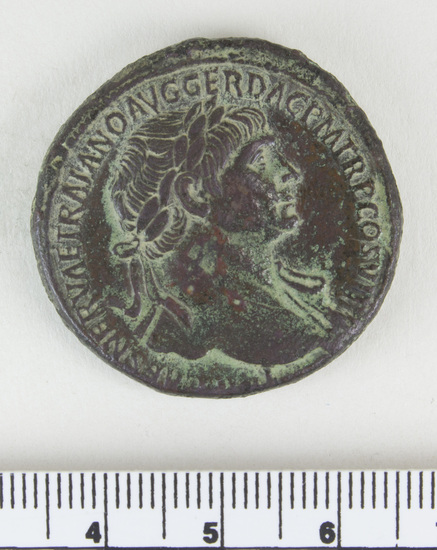 Hearst Museum object 13 of 14 titled Coin: æ sestertius, accession number 8-4007, described as Coin; AE; Sestertius; Roman. Trajan, 104-111 AD. Rome, Italy. Obverse: IMP CAES NERVAE TRAIANO AVG GERM DAC PM TRP COS V PP, Bust laureate and draped. Reverse: [SPQR OPTIMO] PRINCIPI, [ARAB] ADQ [VIS] in ex (as on denarii); S C in field. CF Coin 4008.