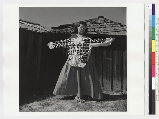 Hearst Museum object titled Black-and-white negative, accession number 15-20239, described as Essie Parrish holding costume; white decorated shirt, front