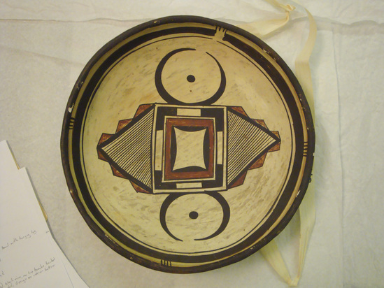 Hearst Museum object 2 of 2 titled Bowl, accession number 2-8343, described as Ceramic, round base, small perforated knob on exterior, geometric design on interior in black and red on buff ground, black rim and framing lines, fire smudged. Molded, painted.