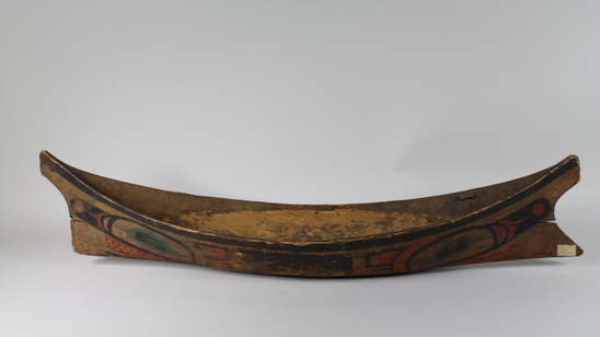 Hearst Museum object 1 of 6 titled Canoe model, accession number 2-10869, described as Model of canoe, painted totemic design in red, green, and black.  Wolf design (fide Charles Brown).