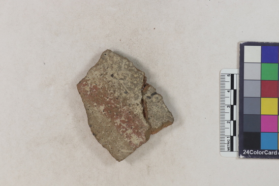 Hearst Museum object 2 of 2 titled Potsherd, accession number 16-8165, described as Potsherd; body, white slip with red stripes Section of Manta on beach currently inhabited. Numbers  8111 to 8194 are sherds picked up on beach at low tide. Glued together.