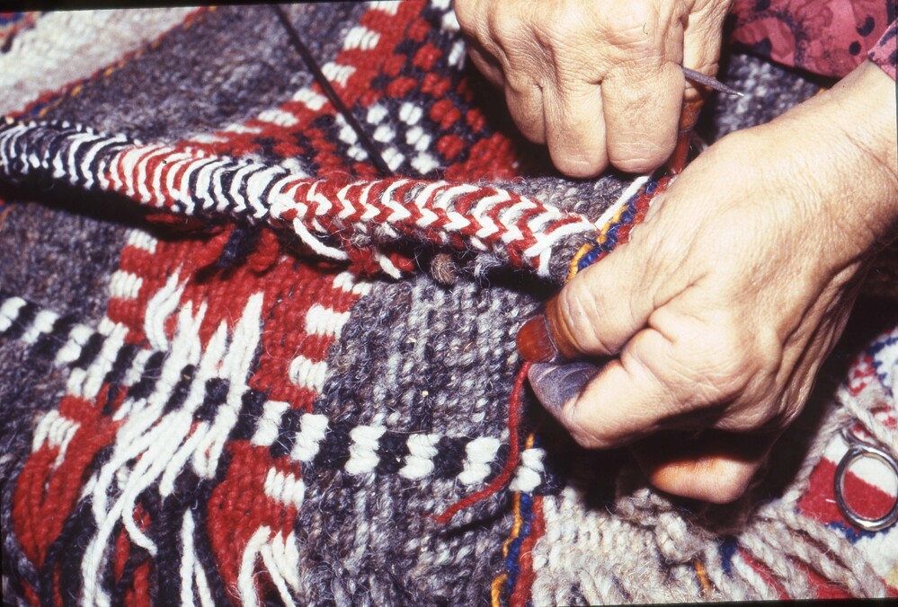 Hearst Museum object titled Color slide, accession number 25-98748, described as 35mm color slide transparency: "thras". Close-up of a person's hands weaving the edge of a textile.