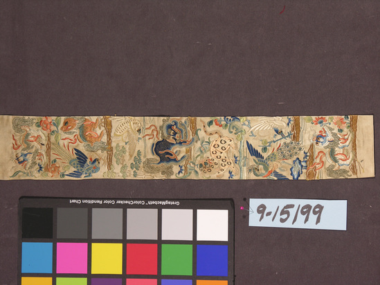 Hearst Museum object titled Textile strip, accession number 9-15199, described as Strip. Silk, gilt paper wrapped yarns. 2.4. Satin weave, embroidered. White ground, varicolored designs. Scene with many animals and birds. 3¼ inches by 22 inches.