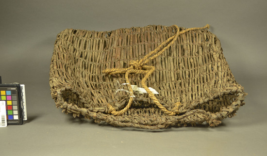 Hearst Museum object titled Basket, kodasu (?), accession number 9-22923, described as A woven basket. The length of the ropes indicate that it was carried on the back.