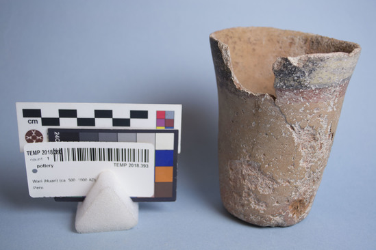 Hearst Museum object 5 of 5 titled Cup, accession number TEMP 2018.393, described as Red ceramic cup with nose in relief, painted face in red, black, and white; thick white and thin black lines on top of vessel.