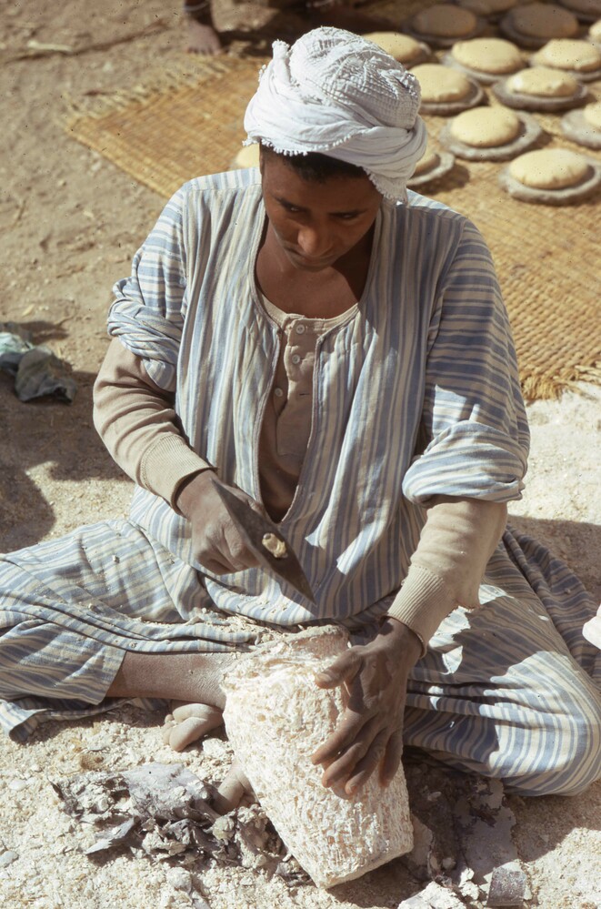 Hearst Museum object titled Color slide, accession number 25-29234, described as 35mm color slide transparency. A man using picks and double-pointed hammers on alabaster vessel.