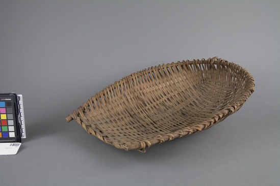 Hearst Museum object 2 of 2 titled Winnower, accession number 10-3, described as Wicker scoop; U-shaped; rice winnower; 18 inches long