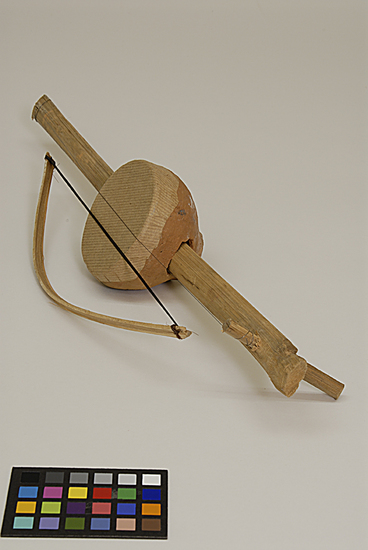 Hearst Museum object titled Musical instrument, accession number 9-10953a,b, described as toy stringed musical instrument w/ bow; clay, bamboo, wood, horsehair, paper & wire;  instrument:  46 cm length; 9 cm width;  bow:  29.5 cm length