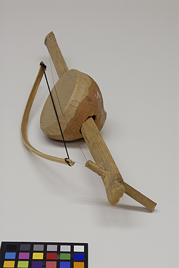 Hearst Museum object 2 of 3 titled Musical instrument, accession number 9-10953a,b, described as toy stringed musical instrument w/ bow; clay, bamboo, wood, horsehair, paper & wire;  instrument:  46 cm length; 9 cm width;  bow:  29.5 cm length