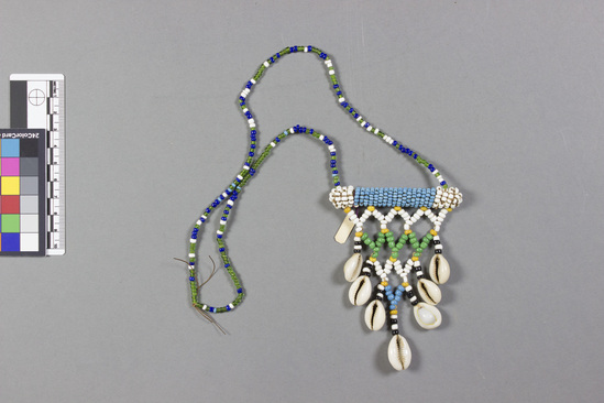 Hearst Museum object titled Beaded shell ornament, accession number 5-1538, described as Beaded Neck ornament, white, yellow, green, blue and 7 cowrie, 122" 309.88cm circumference Made during pre-Boer war period.