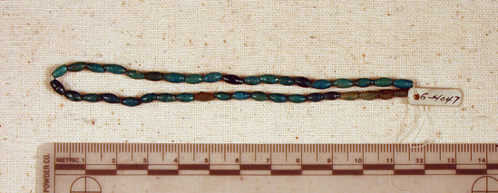 Hearst Museum object titled Beads, accession number 6-14047, described as String blue beads barrel-shaped (biconical), length 24 cm.