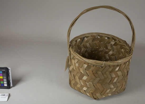 Hearst Museum object titled Basket, accession number 9-17136, described as Basket. Rattan; deep and wide rimmed; with handle, hexagonal bottom, round body; natural fiber color (light).