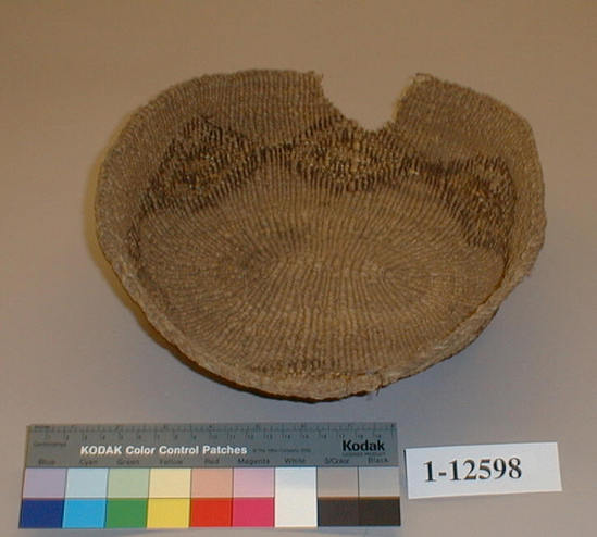 Hearst Museum object titled Cooking basket, accession number 1-12598, described as Cooking basket, maksha; twined. Warp is twisted Tule (Schoenoplectus acutus), weft is Cattail (Typha latifolia). White pattern is Reed (Phragmites vulgaris). Black color is mud-dyed split Tule. Elliptical, with black diamond figure.