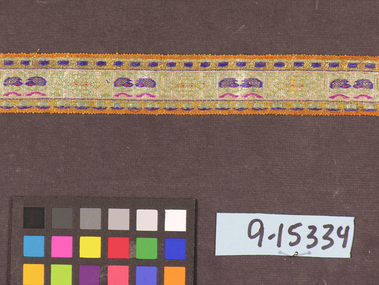 Hearst Museum object titled Ribbon, accession number 9-15334, described as Ribbon. Silk, gilt paper wrapped yarns. Brocaded. Varicolored. Similar to #398, 399. 1⅞ inches by 64 inches.