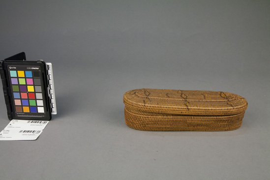 Hearst Museum object 1 of 2 titled Basket and lid, accession number 10-1286a,b, described as Basket with cover; coiled; oval; yellow and brown diamond design on cover; 9½ x 3½ x 2 inches