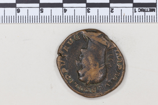 Hearst Museum object 2 of 8 titled Coin: æ sestertius, accession number 8-6243, described as Coin, Æ; Sestertius. 17.85 grams. Philippus Senior, 244-249 AD. Obverse: IMP M IVL PHILIPPVS AVG, Bust facing right, laureate, draped. Reverse: PM TRP II COS PP, SC in exergue, Emperor seated facing left on curule chair, holding globe in right hand and short scepter in left.