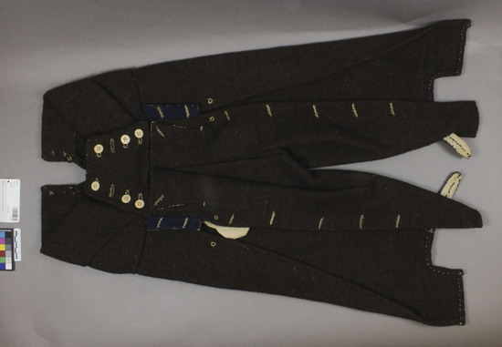 Hearst Museum object titled Pants, accession number 3-117, described as Man’s over pants; heavy brown wool twill, fulled; tab closures navy wool twill; stitched with a 2-ply stiff twine; front closure down legs, but buttons never all sewed on or button holes cut; approximately 68 cm long