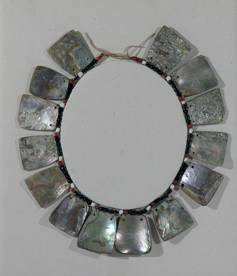 Hearst Museum object titled Necklace, accession number 1-71832, described as Made of Haliotis ornaments. Strung. 14 keystone shaped abalone shells suspended from row of red, white, and black glass beads.