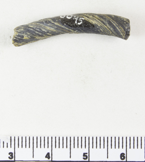 Hearst Museum object titled Bracelet fragment, accession number 9-8045, described as Glass bracelet frag.; opaque black, twisted curved rod; 21 x 6 mm.