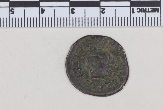 Hearst Museum object 6 of 8 titled Coin: billon bantoninianus, accession number 8-4077, described as Coin; Billon; Antoninianus; Roman. 2.70 grams, 23 mm. Aurelian, 270-275 AD. Mediolanum, Italy. Obverse: IMP C AVRELIANVS AVG, Bust r. radiate. Reverse: VIRTVS MILITVM, Emperor standing r. receives Victory form soldier, in exergue T