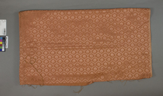 Hearst Museum object titled Textile, accession number 2-62487, described as Strip; cotton, rayon, damask, orange, floral motives, “armure,” Jacquard looms William D McCann