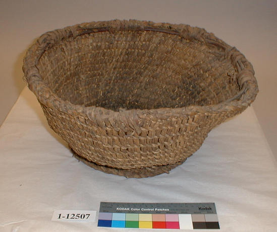 Hearst Museum object titled Basket, accession number 1-12507, described as Seed basket; twined. Warp and weft are split Tule (Schoenoplectus acutus). Rim of Willow (Salix) bound with Willow bark.