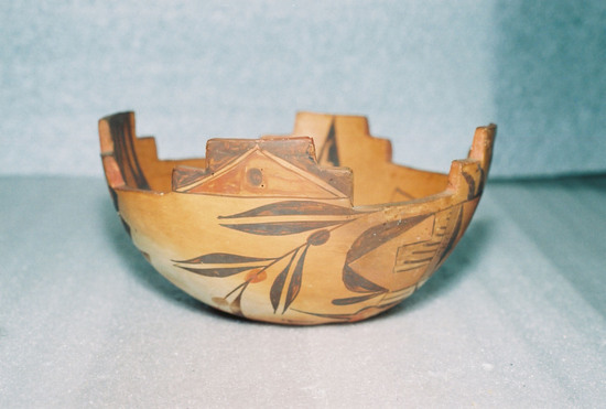 Hearst Museum object 1 of 7 titled Bowl, accession number 2-18708, described as Ceramic, terraced rim, round hole in base, geometric design on interior, stylized bird and floral design on exterior in brown and red on buff/orange ground. Molded and painted.