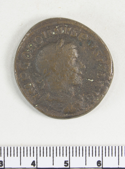 Hearst Museum object 7 of 8 titled Coin: æ sestertius, accession number 8-5924, described as Coin: Sestertius; Æ; Gordianus.Pius - 21.13 grams. Rome, 240-244 AD. Obverse: IMP GORDIANVS PIVS FEL AVG - bust facing right, laureate, draped, cuirassed. Reverse: IOVI STATORI, SC - Jupiter standing facing left, holds long scepter and thunderbolt.