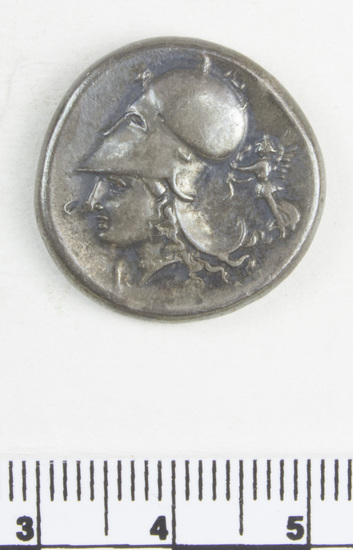 Hearst Museum object 7 of 11 titled Coin: ar stater, accession number 8-5485, described as Coin; AR; Stater; Greek. 8.5435 grams, 21.7 mm.  400-338 BC. Corinth, Greece. Obverse: Pegasus with pointed wings flying l.; below, Ϙ. Reverse: Head of Pallas l. helmeted; to left, “I”; to right, Nike flying l. carrying fillet. Remarks: "condition, excellent.