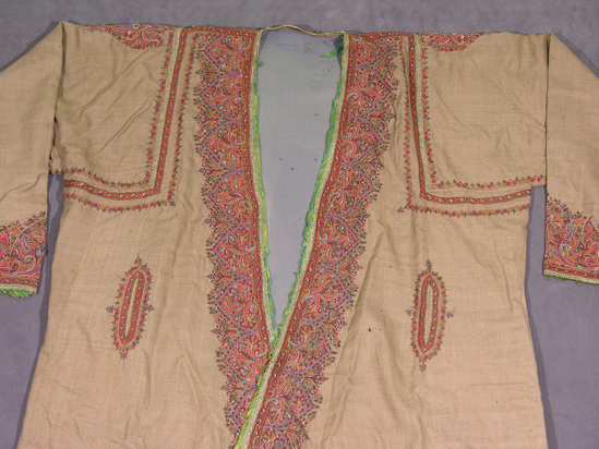 Hearst Museum object 3 of 3 titled Jacket, accession number 9-15695, described as Coat or robelike garment, "choga amlikar".  Wool, flat metal strips, silk binding almost disintegrated.  Twill weave, embroidered, twill weave lining.  Brown ground, varicolored embroidery, green binding, grey lining.  Floral decoration.  48½ inches long.