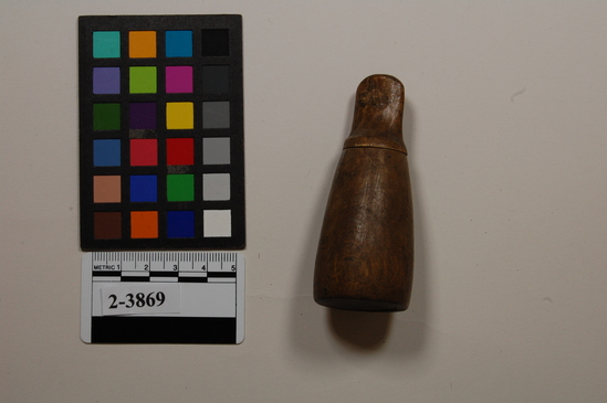 Hearst Museum object titled Box, accession number 2-3869, described as Small, tapered, cylindrical carved wooden container; bottle-like shape with a stopper and a flat bottom. Eskimo box for gun caps.