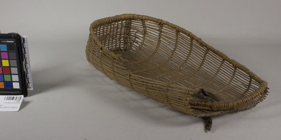 Hearst Museum object 2 of 2 titled Cradle, accession number 1-27696, described as Basketry cradle, open twined. Per Ralph Shanks:  Twined openwork baby basket, with commercial cloth tie.  The warp material is probably willow.  The wefts are of uncertain material.  At the foot there is plain twining, spaced closer than the rest of the basket.  The rim is covered with possibly conifer root, reinforced with two rods.  Starting at the foot there is one unpaired weft row, followed by several sets of two weft rows, with the uppermost set having three weft rows.  The basket has an up to the right slant of weft twist.  The basket is from Northwestern California.