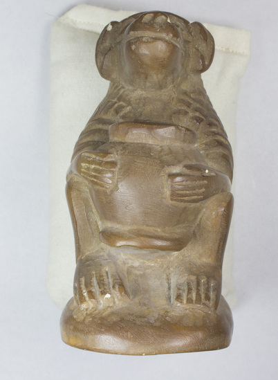 Hearst Museum object titled Baboon figurine, accession number 5-757, described as Figurine, baboon, holding pot, brown stone