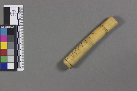 Hearst Museum object titled Bone pipe, accession number 5-9891, described as Pipe; cylindrical; bone; two incised zig-zag lines; l. 10.7 cm.