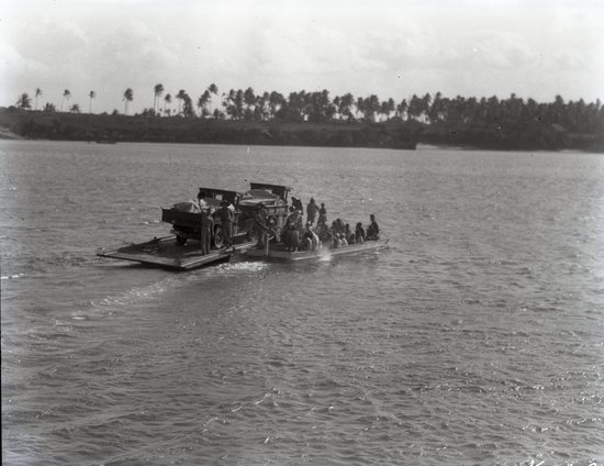 Hearst Museum object titled Black and white negative, accession number 15-32286, described as 4" x 5" Negative. September 26, 1928. Colorado African Expedition leaves from Mombasa to start journey on West Coast. Both trucks and expedition members on ferry towards coast.  Hoefler's original description: "Start of the Colorado African Expedition. On September 26th, 1928, under the leadership of Paul L. Hoefler, the expedition left the Island of Mombasa for its long trek to the West Coast, a journey of 5154 miles by the nearest possible way across the center of the greatest continent of this world. It required ten months and six days, during which a total of 13,282 miles were driven, and the expedition arrived at Lagos, Nigeria on July 30th 1929."