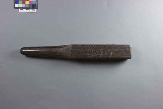 Hearst Museum object 2 of 6 titled Tapa beater, accession number 11-40681, described as Quadrangular blade has 2 sides with deep longitudinal grooves, one pitted side, one side with shallow longitudinal grooves with some incised dots; rounded handle. Made of carved hardwood.
