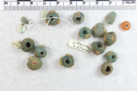 Hearst Museum object titled Beads, accession number 6-21529, described as Blue beads, one carnelian bead, ornamented beads, with red-centered shell discs. No date given.